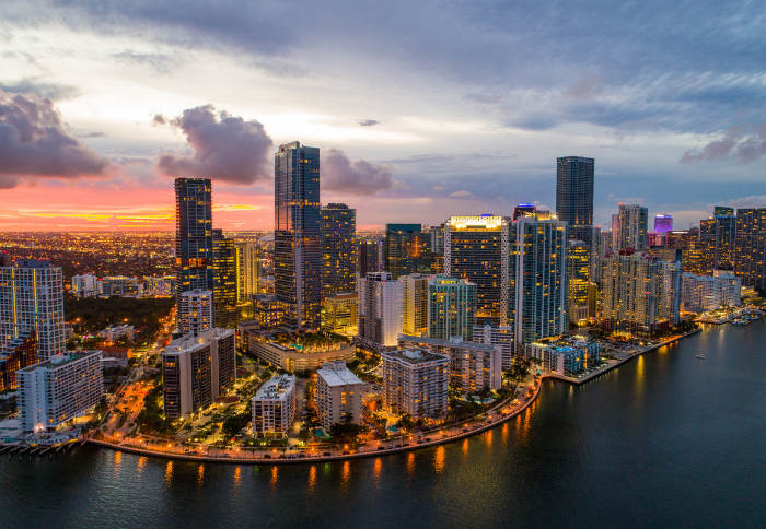 Florida real estate skyline at sunset highlighting Miami’s urban waterfront and property market landscape