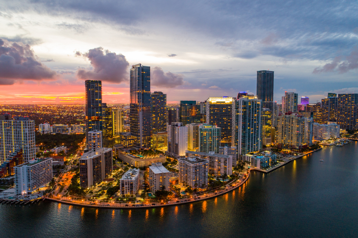 Florida real estate skyline at sunset highlighting Miami’s urban waterfront and property market landscape