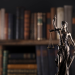 Lady Justice statue before law books representing Jocelyne A. Macelloni’s appointment as Vice Chair